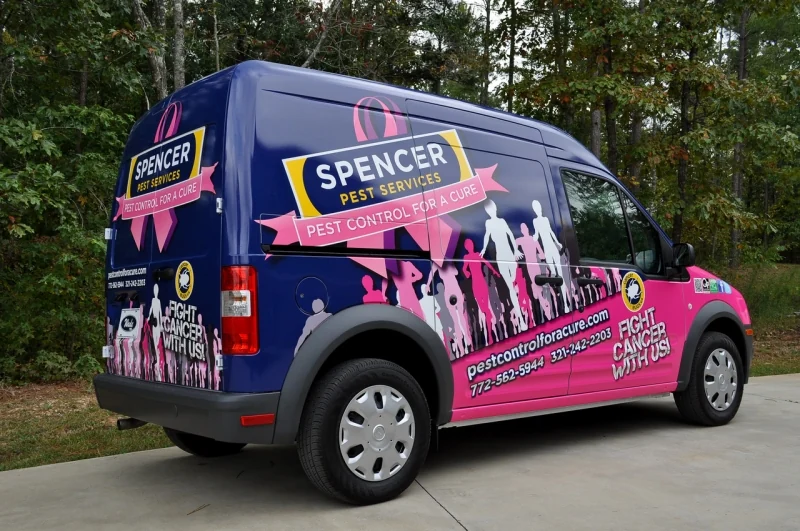 Spencer Pest Services van with a navy and pink Pest Control for a Cure wrap